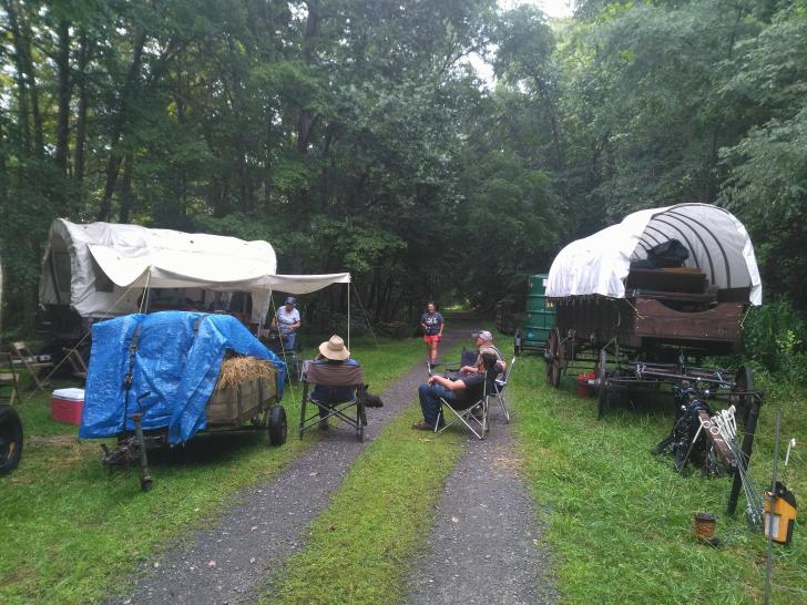 A wagon train camping on the Greenbrier River Trail